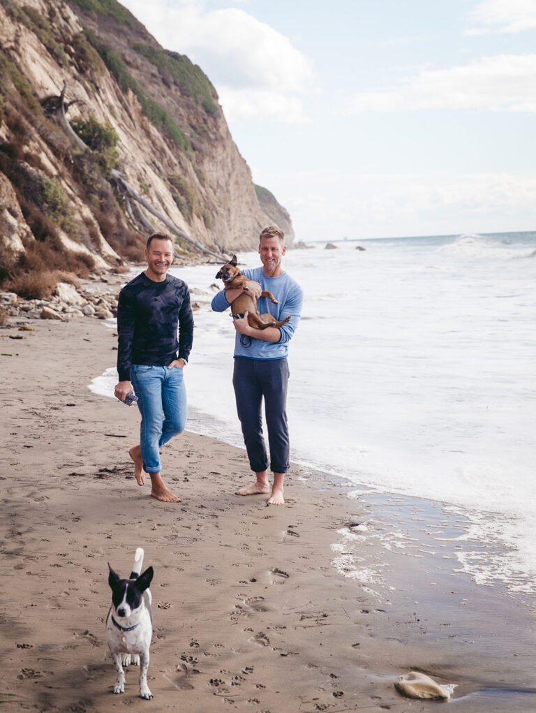 Couple on the beach with dogs