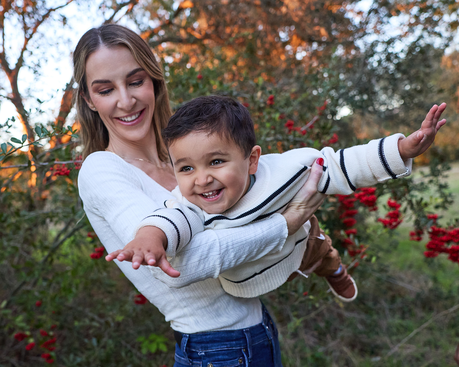 Small boy flying held by his mom